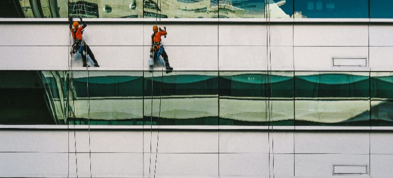 experts cleaning windows on a building