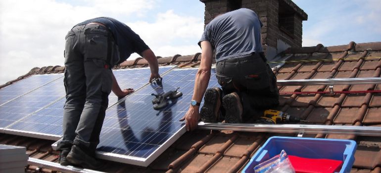 two men installing solar panels