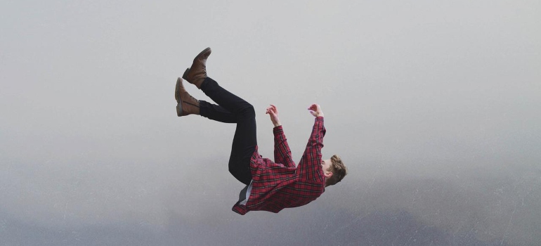 A man in plaid shirt falling