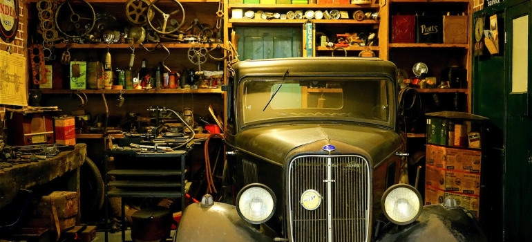 A garage with a vintage car stored inside.