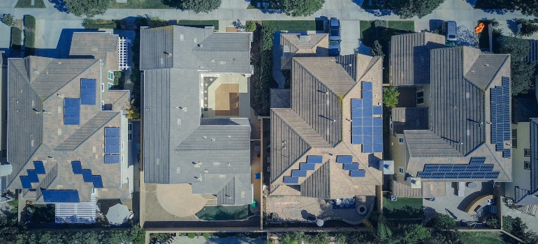 A top-down view of several houses boasting different types of solar panels.