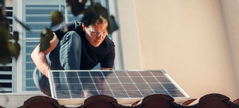 man installing solar panels on his Las Vegas home