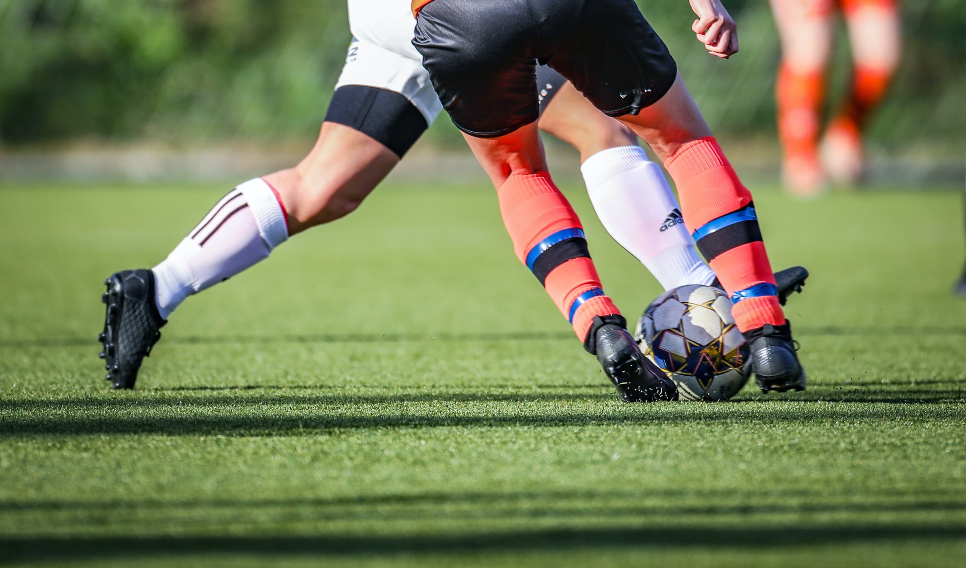 What are the benefits of artificial grass for sports facilities?