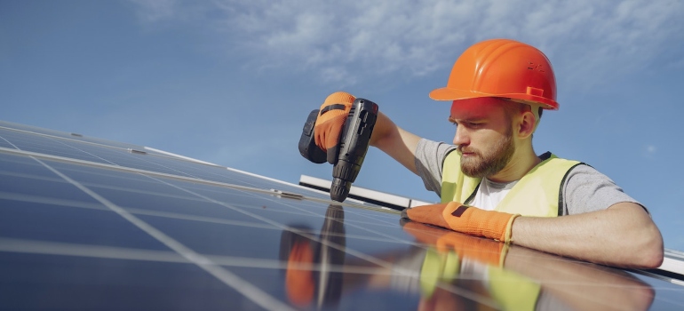 An electrician installing a solar panel.