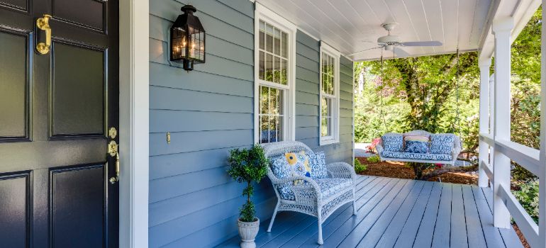 front porch with blue accents and furniture