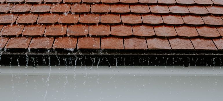 family home roof during a pressure washer cleaning