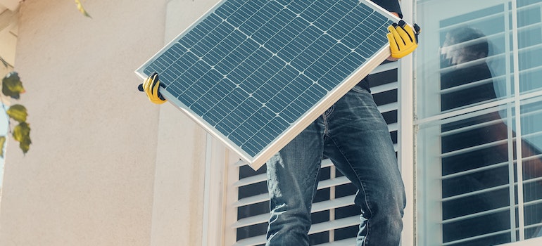 A man holding solar panel