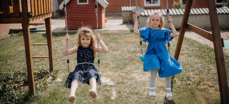 two girls on swings
