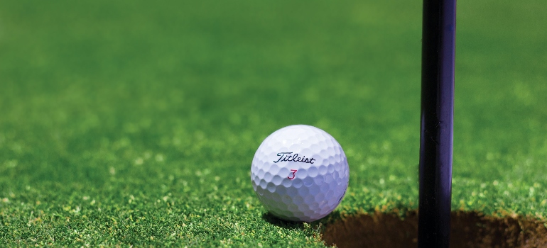 golf ball on a putting green is one of the top indoor uses for artificial grass