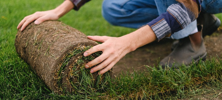A person installing artifical turf