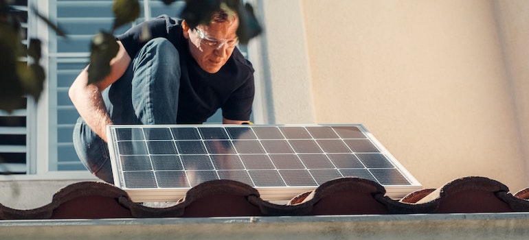 A man fixing solar panel