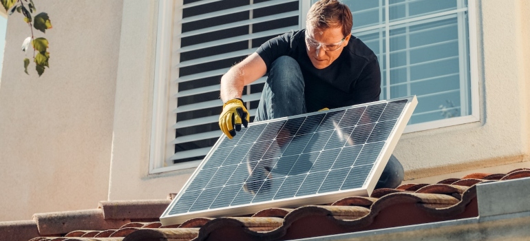 a man installing a solar panel 