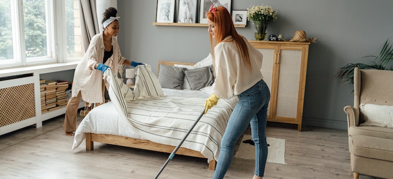 A woman cleaning a bedroom