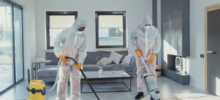 Two people disinfecting a home